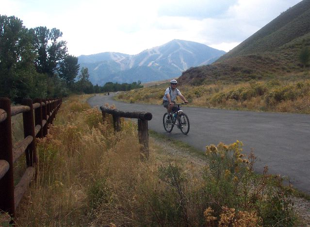 Sam on Bike with Ski Slope in Background